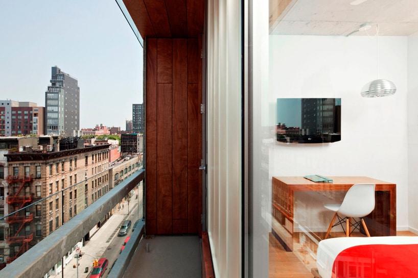 Close-up architectural detail of the Stratford Aparthotel facade showing sawtooth geometry and privacy fins.