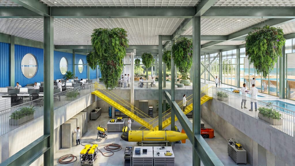 Interior view of the Boiler Building Ocean Lab featuring yellow stairs, hanging plants, and marine research equipment demonstrating adaptive reuse.