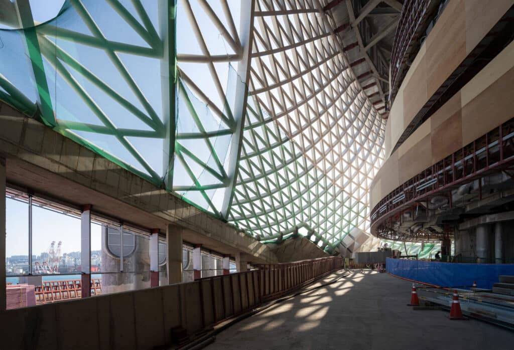 The Busan Opera House viewed from the water, emphasizing its connection to the maritime environment.