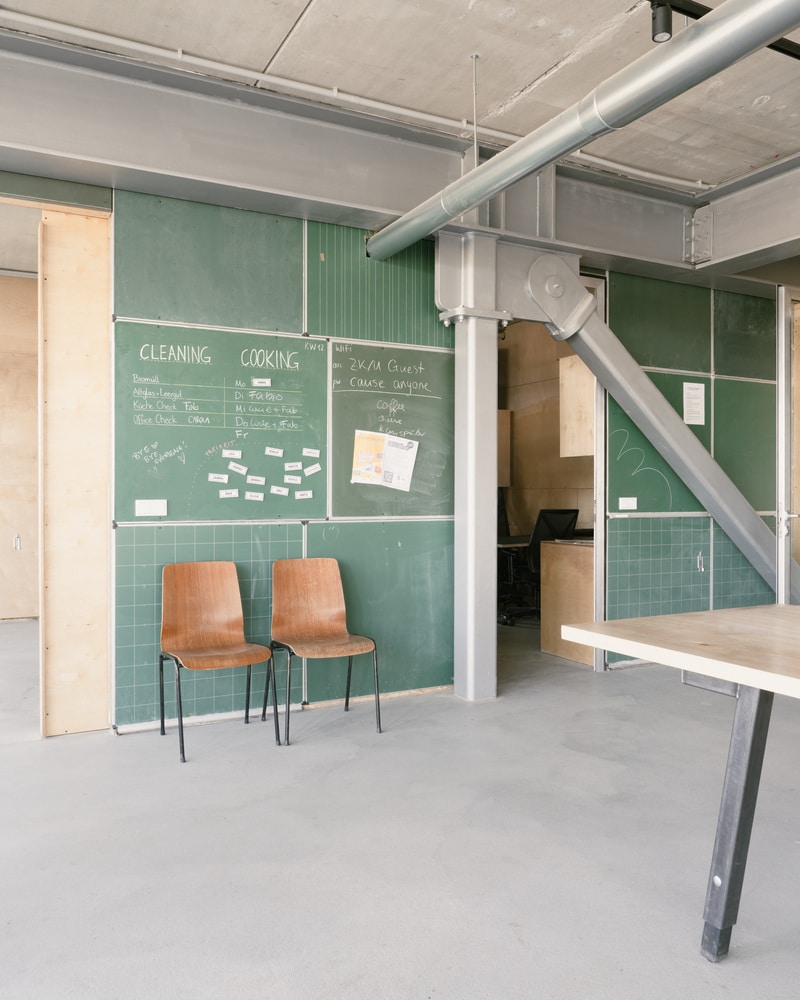 A close up view of the new steel staircase and glass facade connecting with the original brick structure of the ZK/U Center.