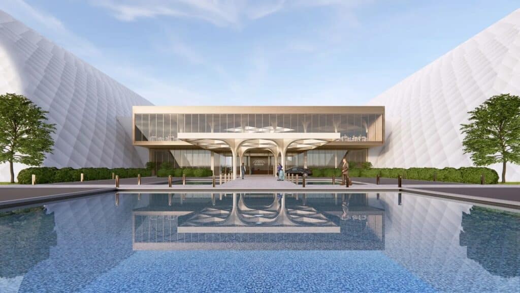 A close-up view of a putting green and sand bunker inside the domed facility, showing the texture of the artificial turf.