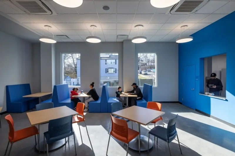 Naturally lit lobby caf&eacute; and social seating area inside the flood-resilient architecture project. File Name: remington-clubhouse-interior-cafe-seating.jpg