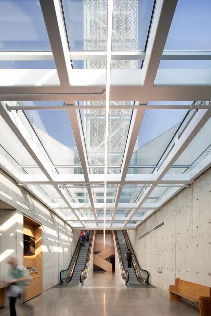 The glass bell tower of Saint Joseph's Oratory glowing at dusk against the mountain landscape.