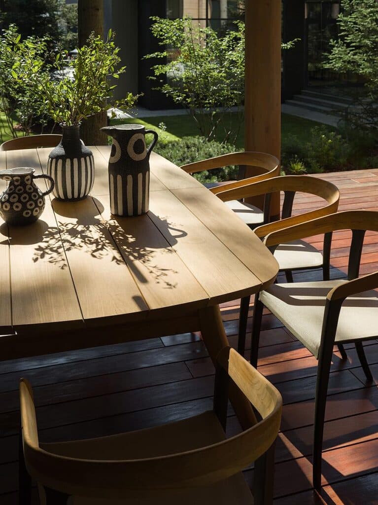 Terrace outdoor dining and lounge area featuring Royal Botania Zidiz table, Jive chairs, Poliform Magnolia sun lounger, and Contardi Tenebra lighting