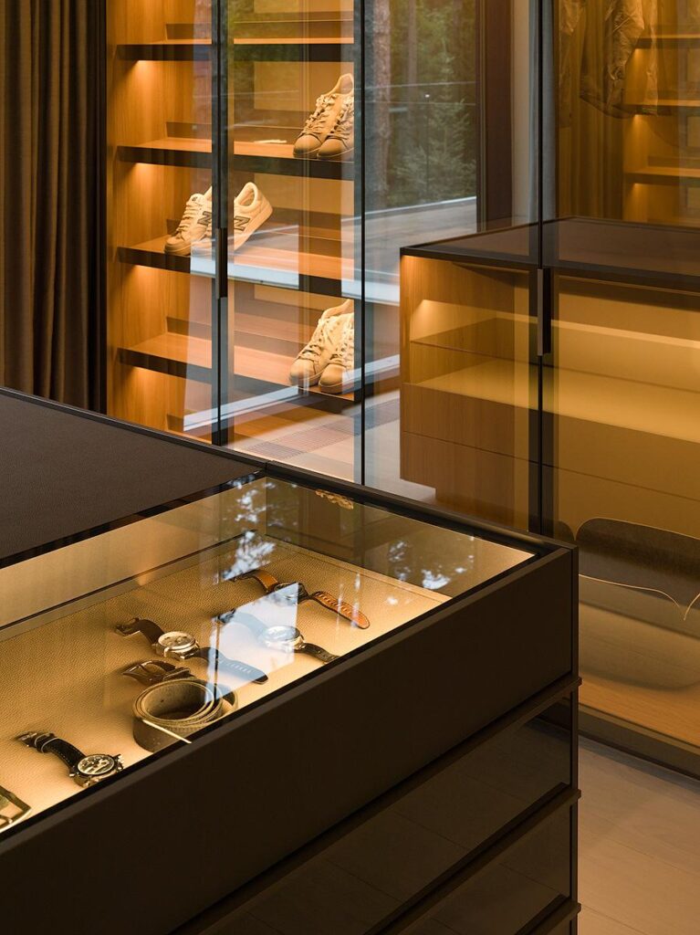 Master suite walk-in closet featuring Poliform Senzafine wardrobes, wardrobe island, and Poliform New York pouf