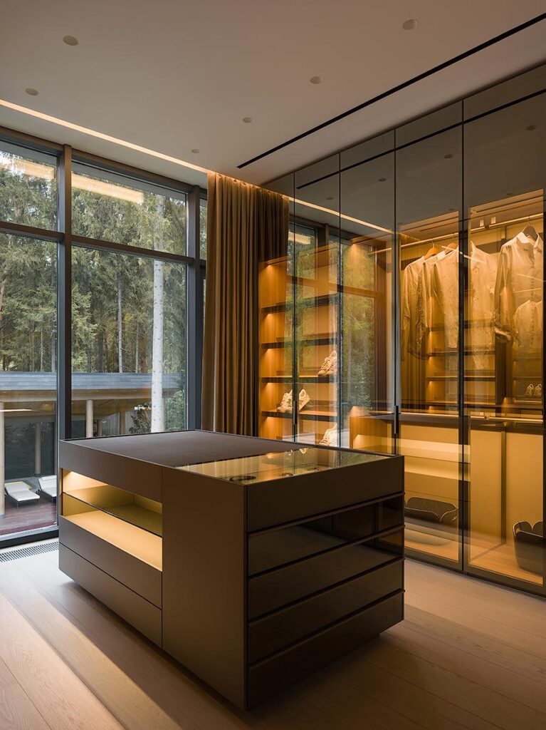Master suite walk-in closet featuring Poliform Senzafine wardrobes, wardrobe island, and Poliform New York pouf