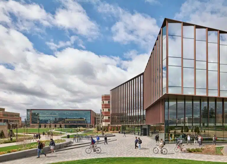 Exterior view of the ECoRE building at Penn State University showing the glass facade and campus pedestrian pathways.