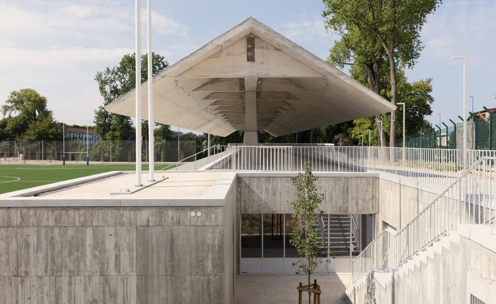 Architectural detail of the wing-shaped prestressed concrete roof and entrance courtyard at Ramalde Sports Park.