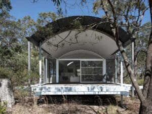 Front view of the Ball-Eastaway House showing the vaulted roof and elevated deck integrated with the Australian bush.