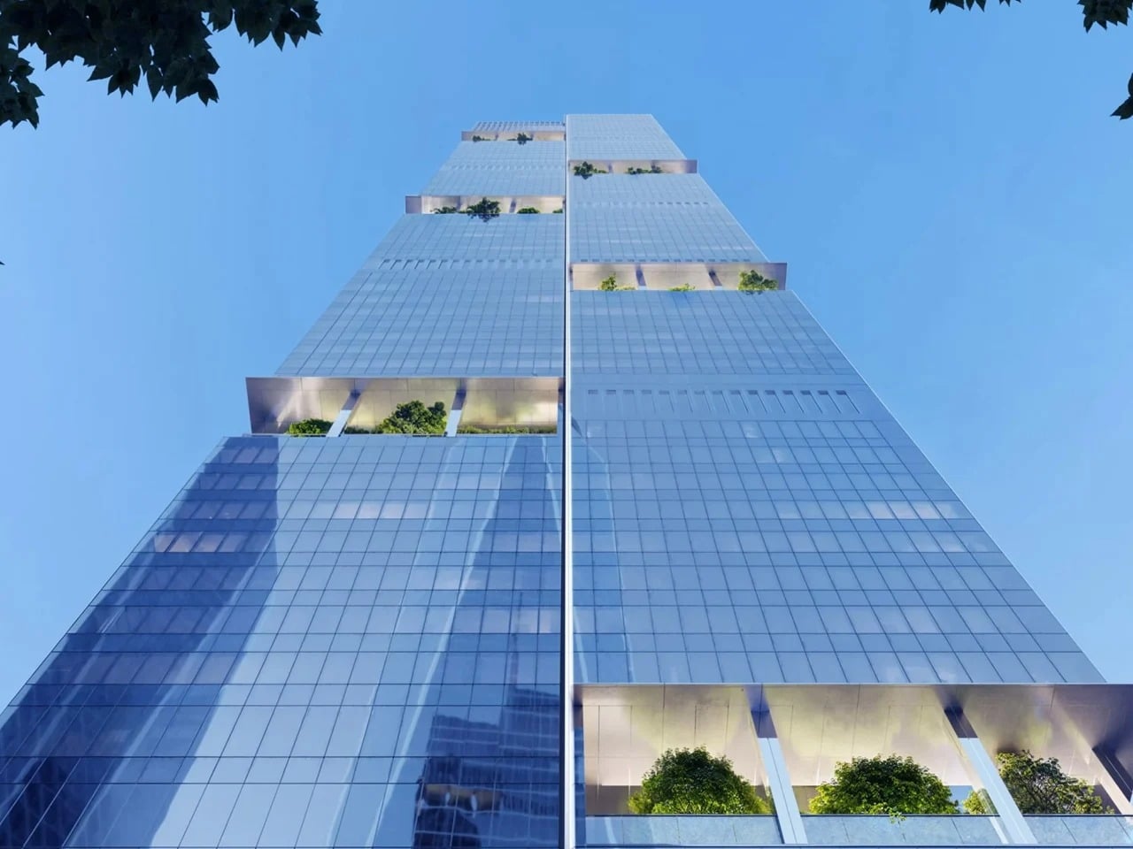 Low-angle worm's-eye view of 2 World Trade Center featuring a glass facade and integrated sky gardens with green trees.