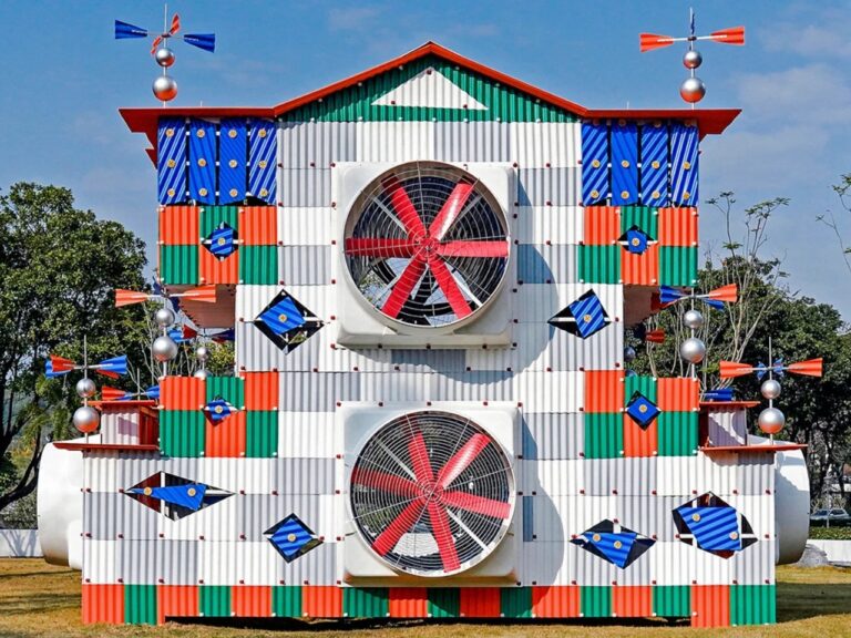 Front elevation of Clock House No. 2 featuring a symmetrical facade with two large industrial fans and colorful corrugated metal panels in red, green, and blue.