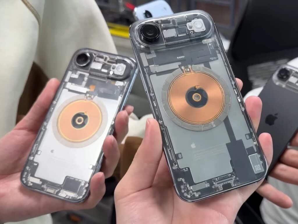 Hands holding a modified transparent iPhone next to an original black iPhone for comparison.