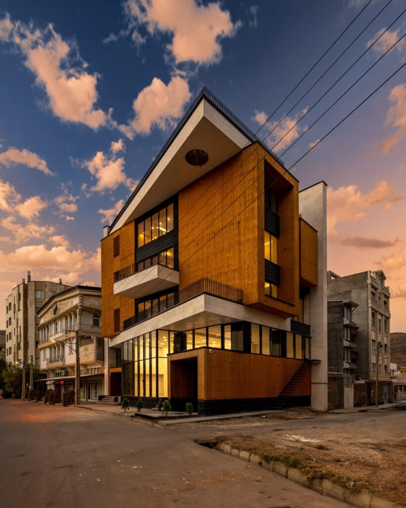 Perspective view of Ramand Ho building at sunset, showing the intersection of the street and narrow alley.