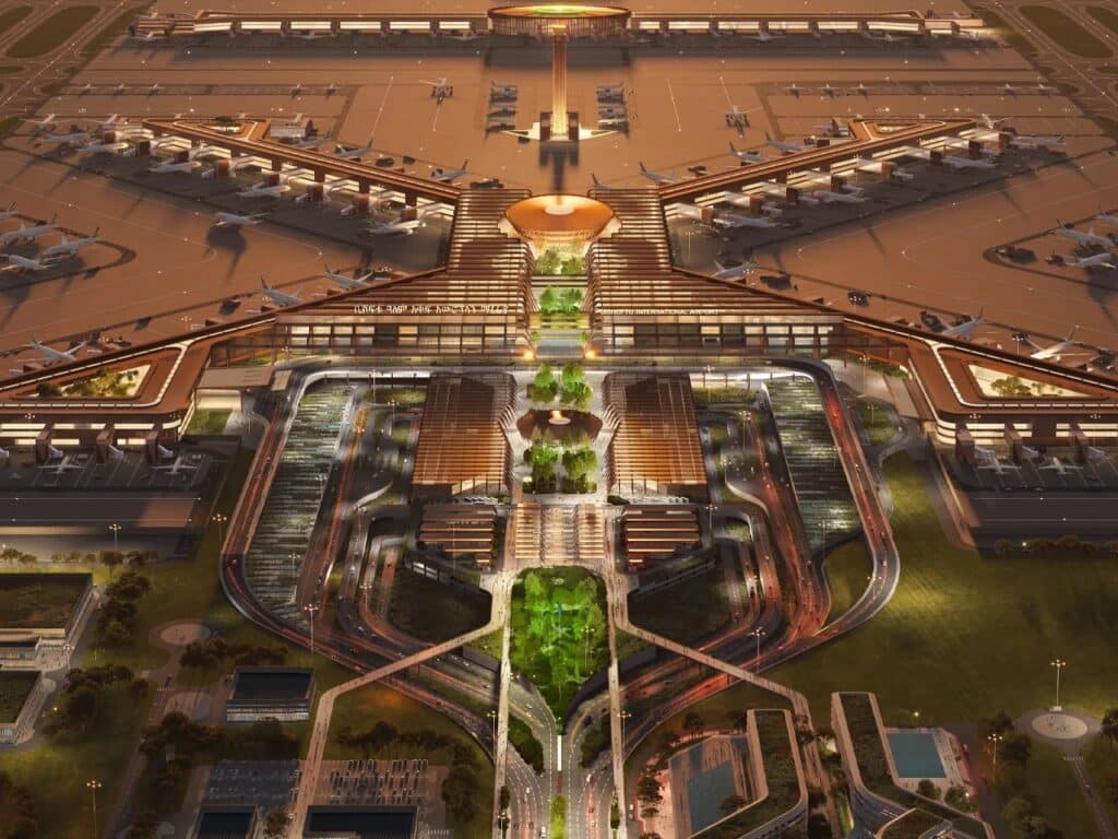 Night view of the main entrance and terminal of Bishoftu International Airport with illuminated runways and urban landscaping.