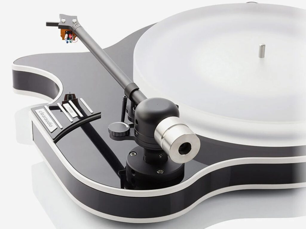 Close-up of a black gloss guitar-shaped turntable tonearm and frosted platter, highlighting precision mechanical components.
