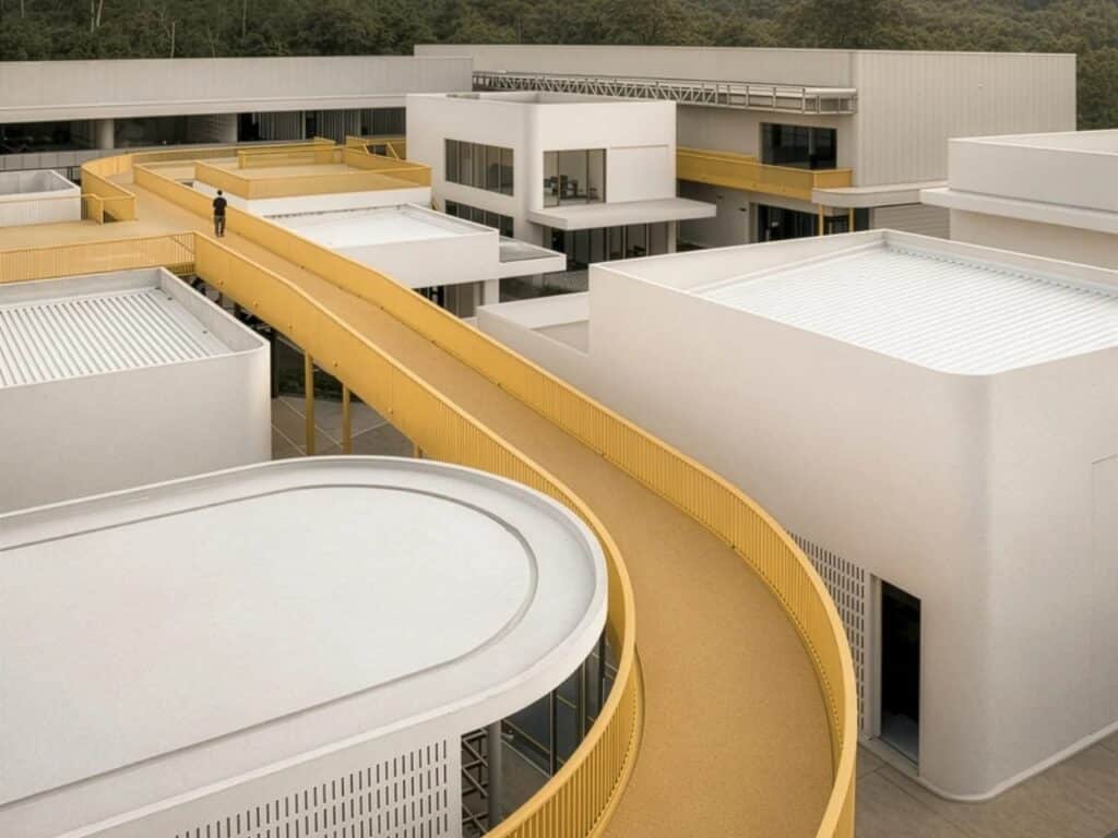 Perspective view of white minimalist buildings with a long yellow pedestrian ramp connecting different levels at My Front Yard.