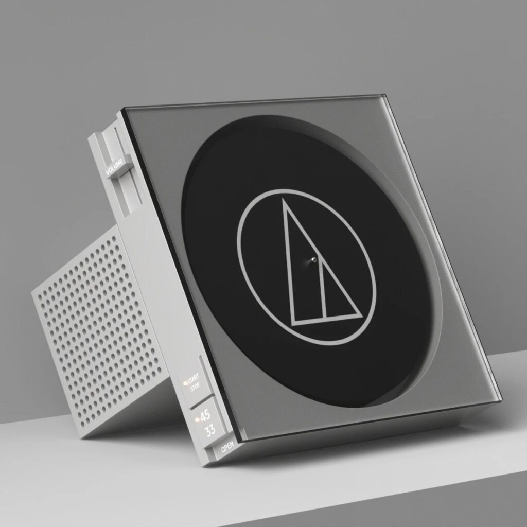 A sleek silver and grey vinyl player positioned at an angle, emphasizing its T-shaped geometric structure and clean UI buttons.
