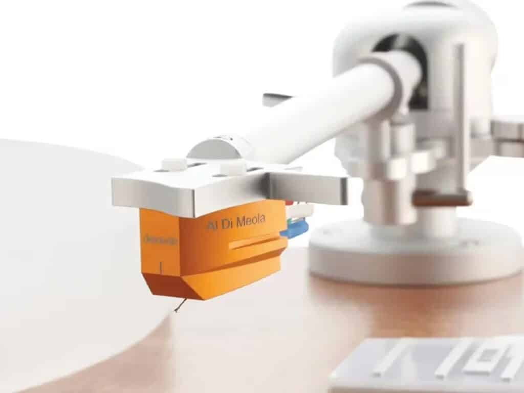 Macro view of a high-fidelity phono cartridge with "Al Di Meola" inscription on a silver tonearm.