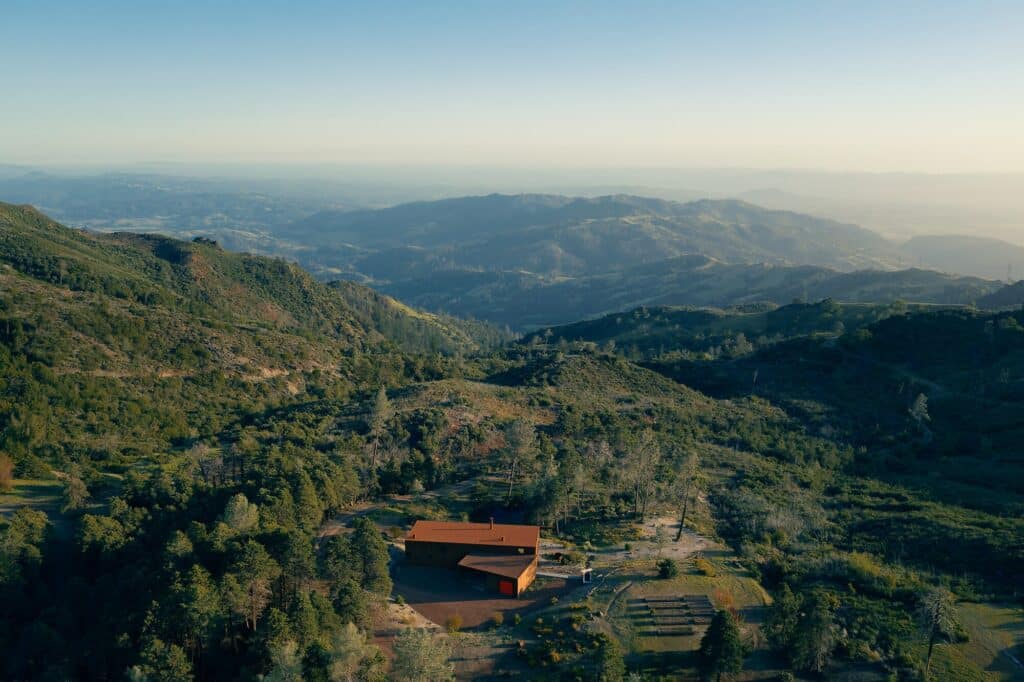 Aerial drone shot of the Healdsburg house isolated in the forested mountains of Northern California.
