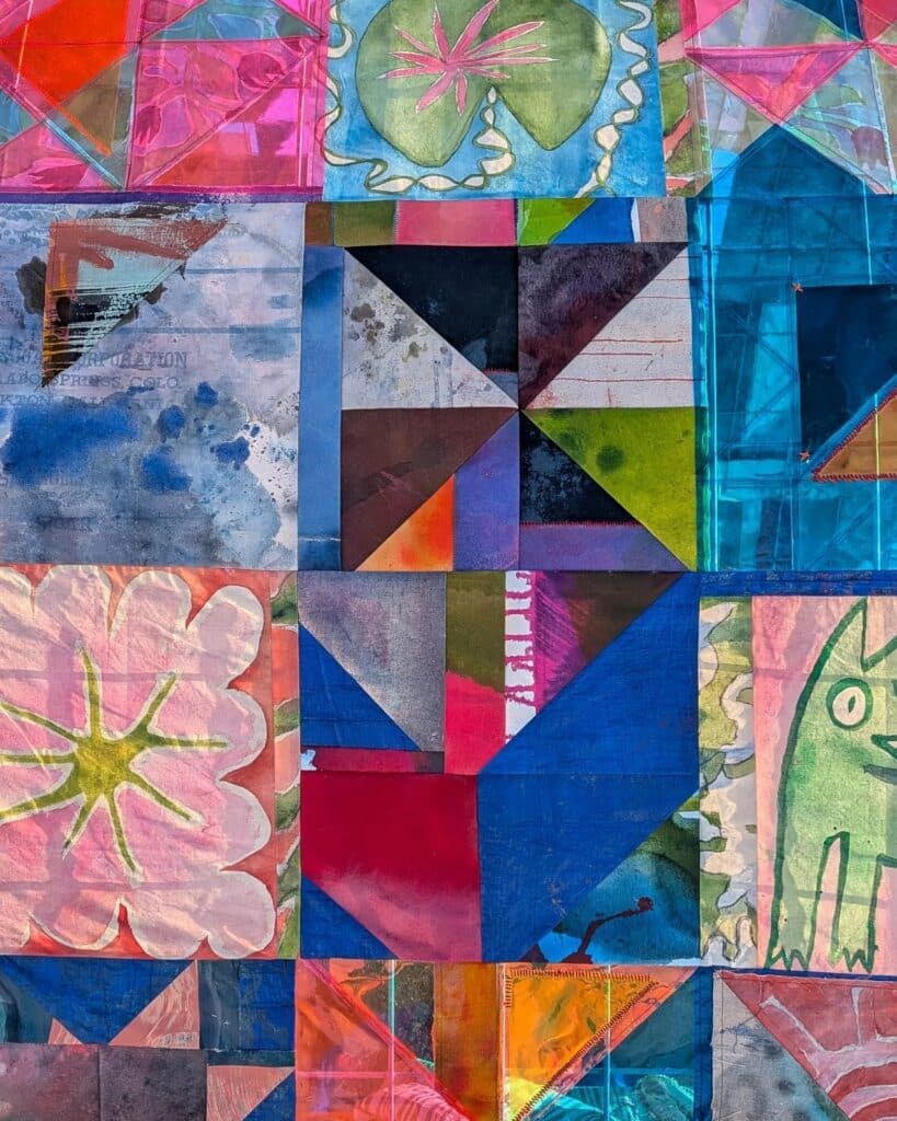 Macro view of various quilt squares featuring folk art illustrations, floral patterns, and geometric shapes in vibrant colors.