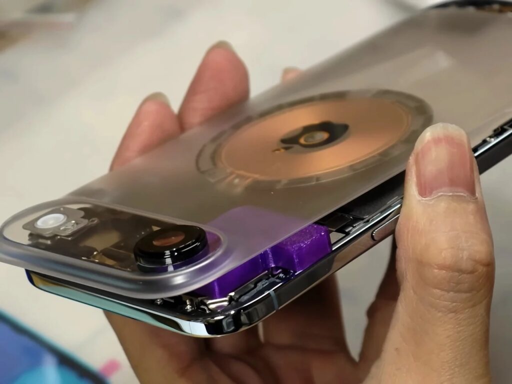 Side view showing the gap between a transparent back panel and the stainless steel frame during assembly.