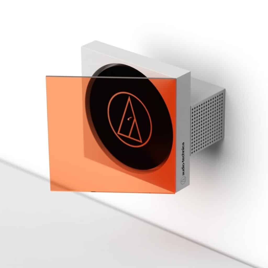 A wall-mounted vinyl record player concept with a white body and orange transparent cover, displaying the record as wall art.