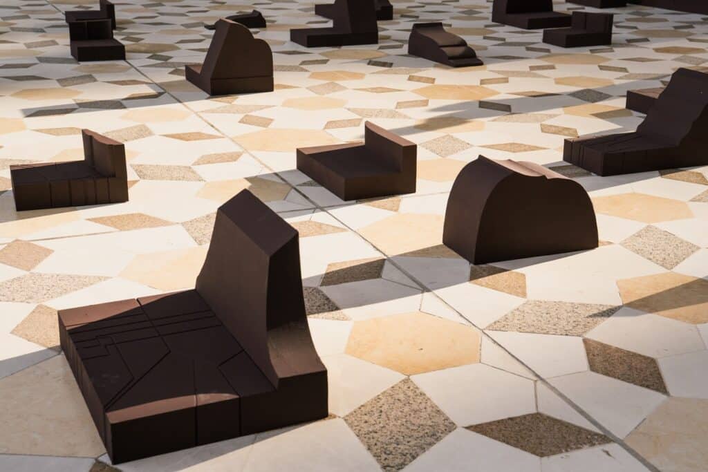 Close-up of individual modular seats on a patterned stone floor, showing the rhythmic distribution of the Counterspace design.