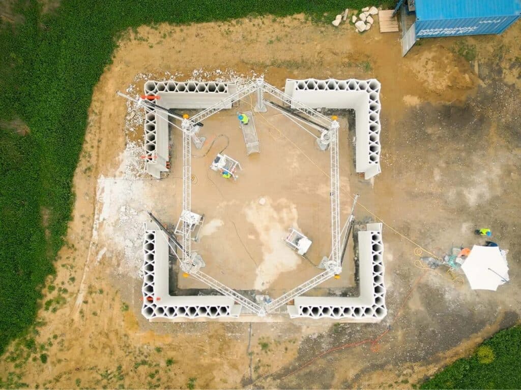 Symmetrical top-down view of the hexagonal 3D printing rig and the developing floor plan of the sustainable farm.