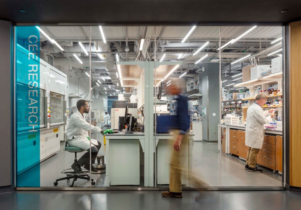 Researchers working inside the CEE Research laboratory viewed through a glass wall at ECoRE.