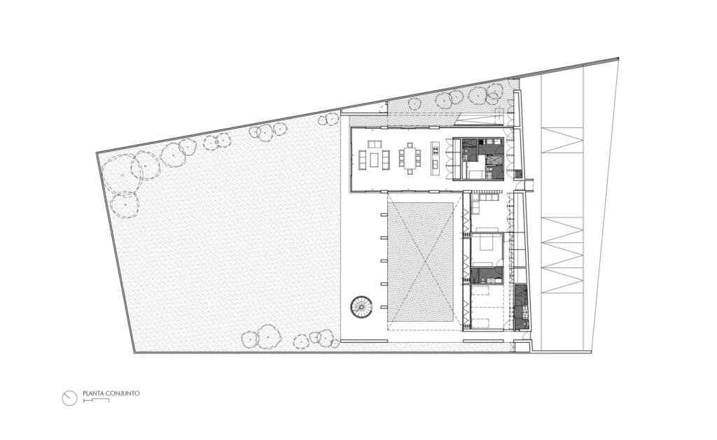 A professional architectural site plan showing the L-shaped building footprint, courtyard, and surrounding landscape.