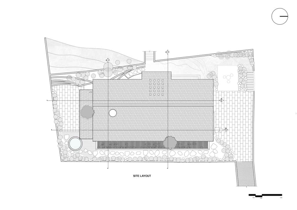 Architectural site layout plan of the residential building showing the building footprint, surrounding topography, and landscape elements.
