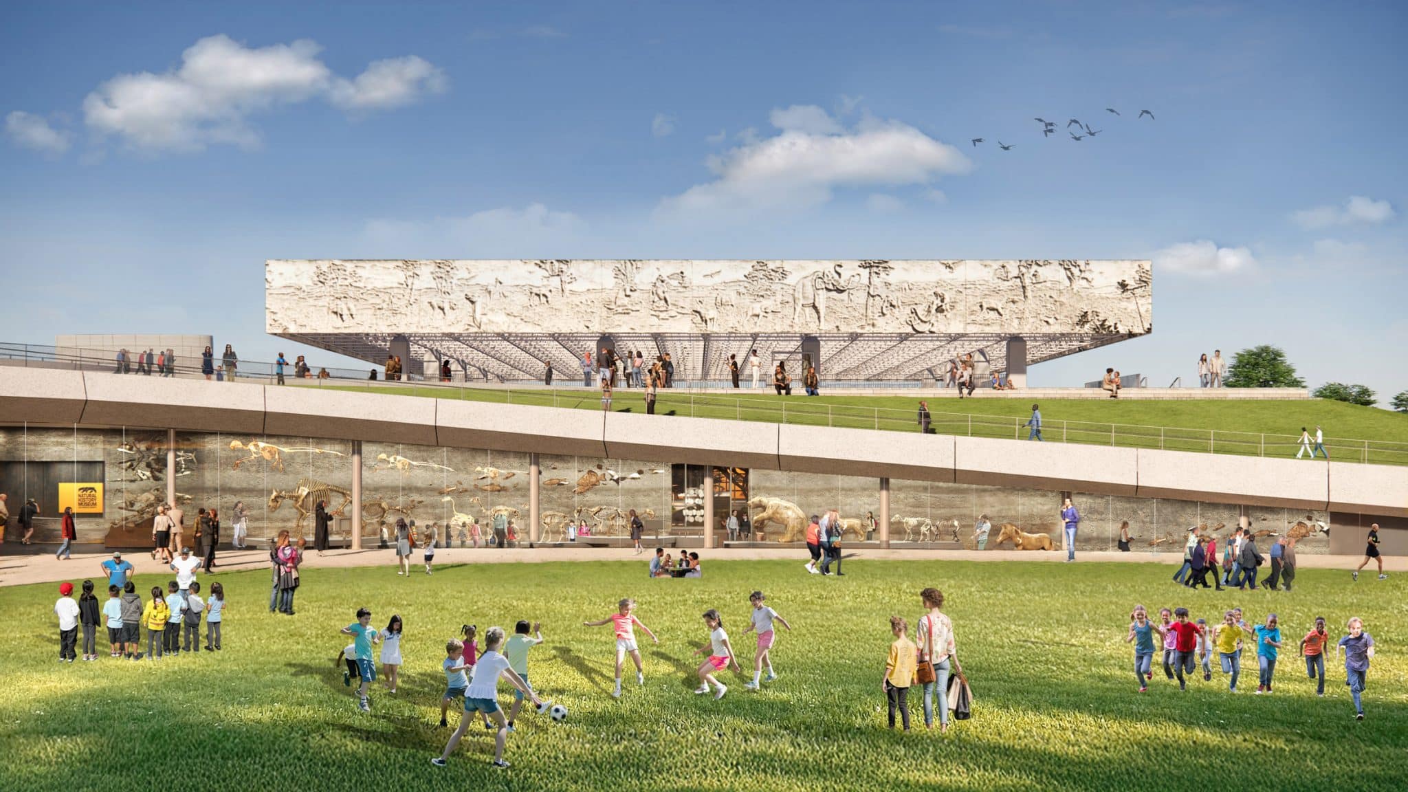 An architectural rendering of a modern museum set in a green park. In the foreground, children play on a lush lawn. Behind them, a long, glass-walled walkway displays skeletal remains of prehistoric animals. In the background, a large, rectangular building with a detailed stone relief of Ice Age creatures sits atop a grassy slope under a clear blue sky.