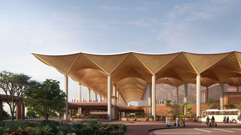 Exterior drop-off zone under the geometric wooden roof canopy of the new Kinshasa Airport terminal.