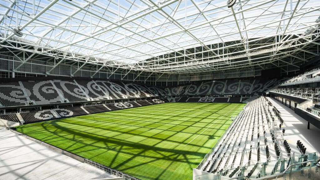 Interior view of Christchurch Stadium showing the transparent ETFE roof and seating with Māori patterns