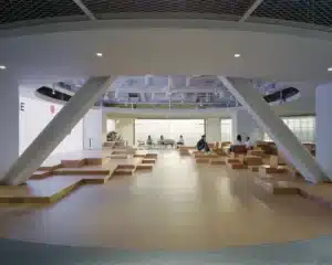 Central forum with stepped wooden seating in a modern financial office design