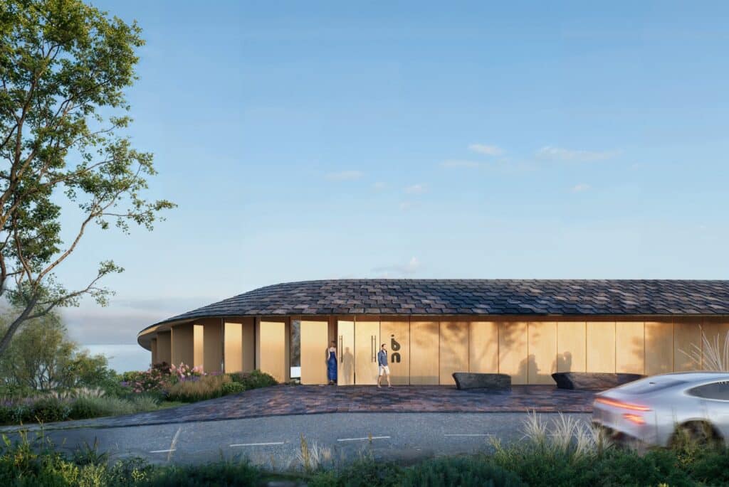 Street-level entrance of the mass timber pavilion featuring a slate roof and vertical wooden lamellas.