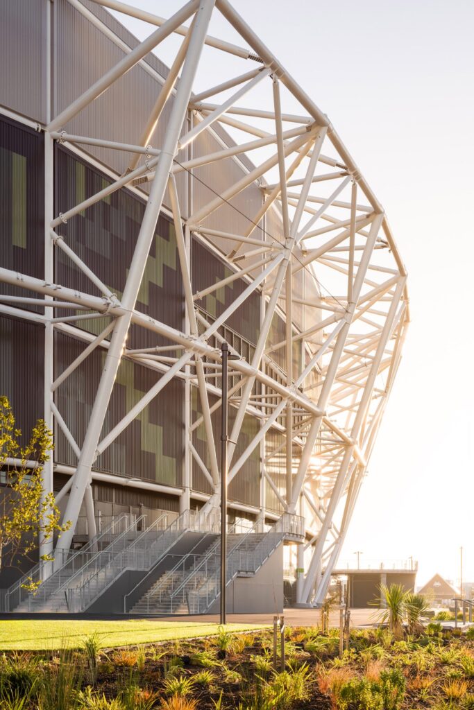 Sunlight hits the white steel facade framing Christchurch Stadium exterior