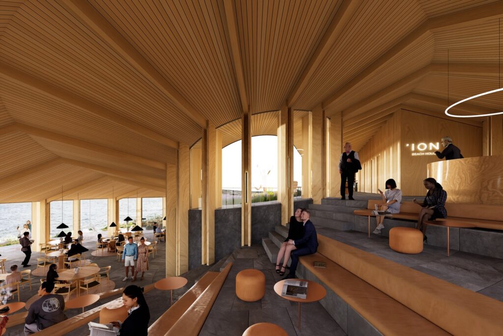 Warm interior view of the mass timber pavilion showing a terraced reading lounge and cafe overlooking the water.