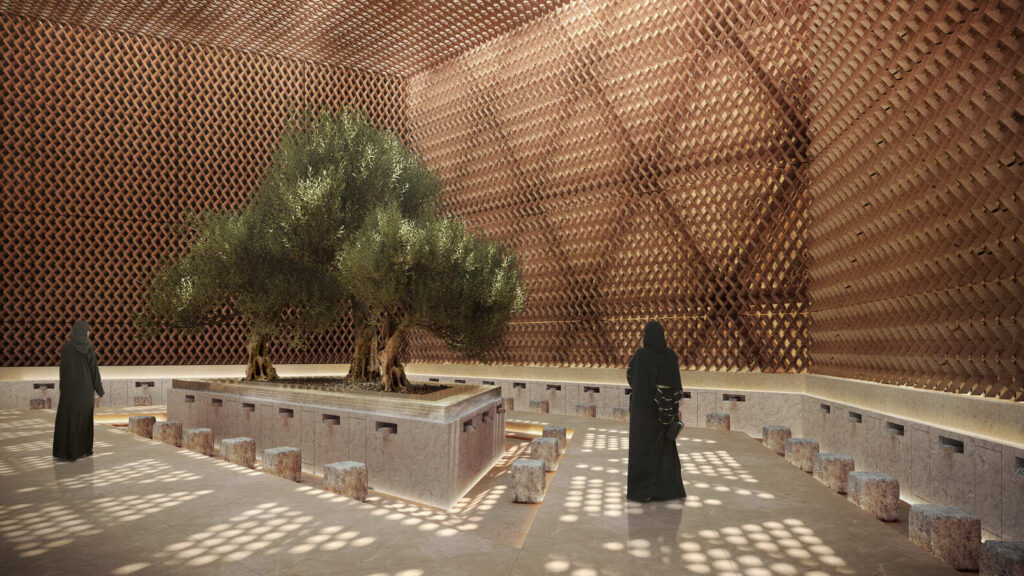 Indoor ablution area featuring a central planted tree and intricate lattice walls filtering sunlight.