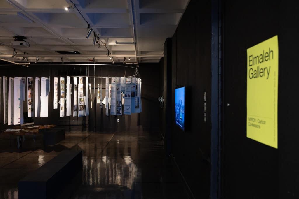 Installation team assembling the MVRDV Carbon Storyline panel at Carbon Confessions exhibition