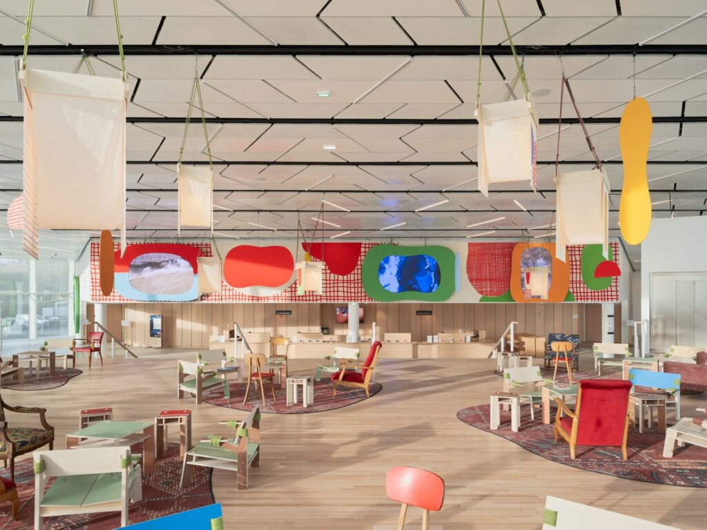 Flexible seating arrangements near the glass facade showcasing the theatre redevelopment project.