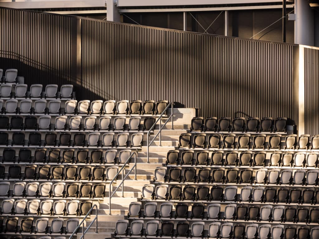 Empty black and white seating rows inside Christchurch Stadium showing cultural patterns