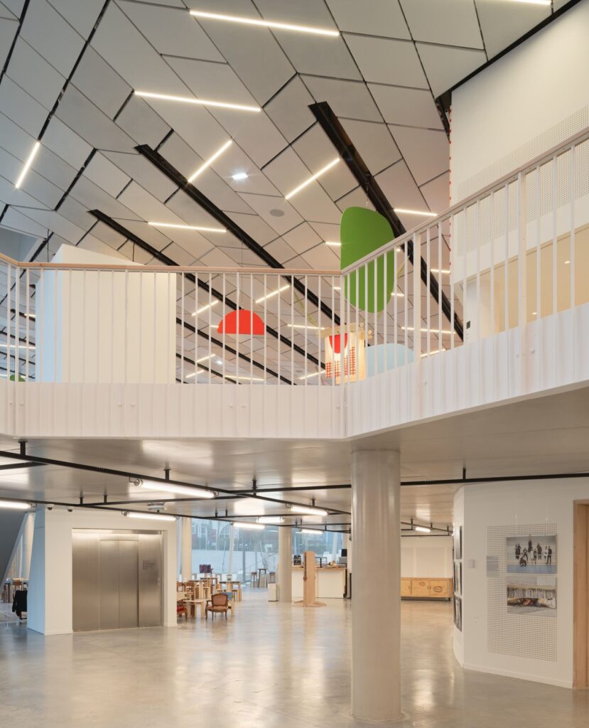 Multi-level interior view of the theatre redevelopment showing an elevator and balcony corridors.