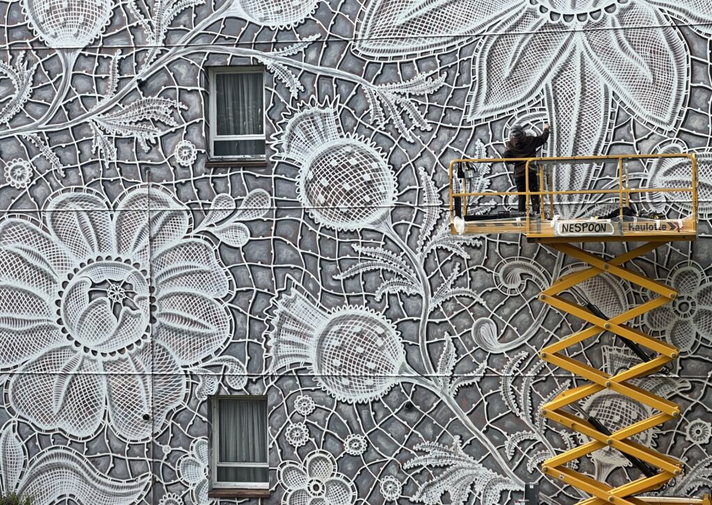 NeSpoon lace inspired mural in Aberdeen, Scotland transforming traditional lace patterns into large scale architectural street art.