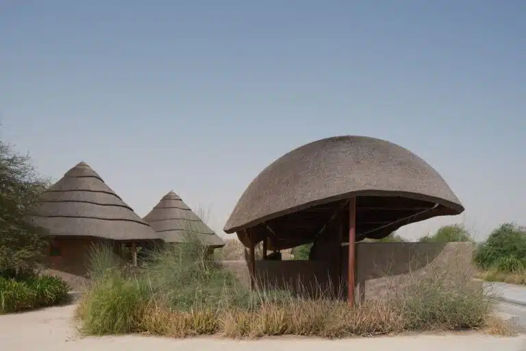 Sustainable thatched roof pavilions in Sharjah Bridi Park designed by Urko Sanchez Architects.