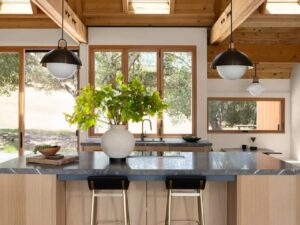 Modern kitchen island with marble countertop and pendant lighting in Glen Ellen house, Sonoma.