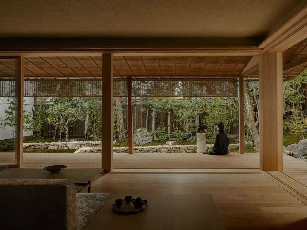 Interior view of a traditional Sukiya-style house in Kyoto featuring a wide wooden veranda (Engawa) overlooking a Zen garden.