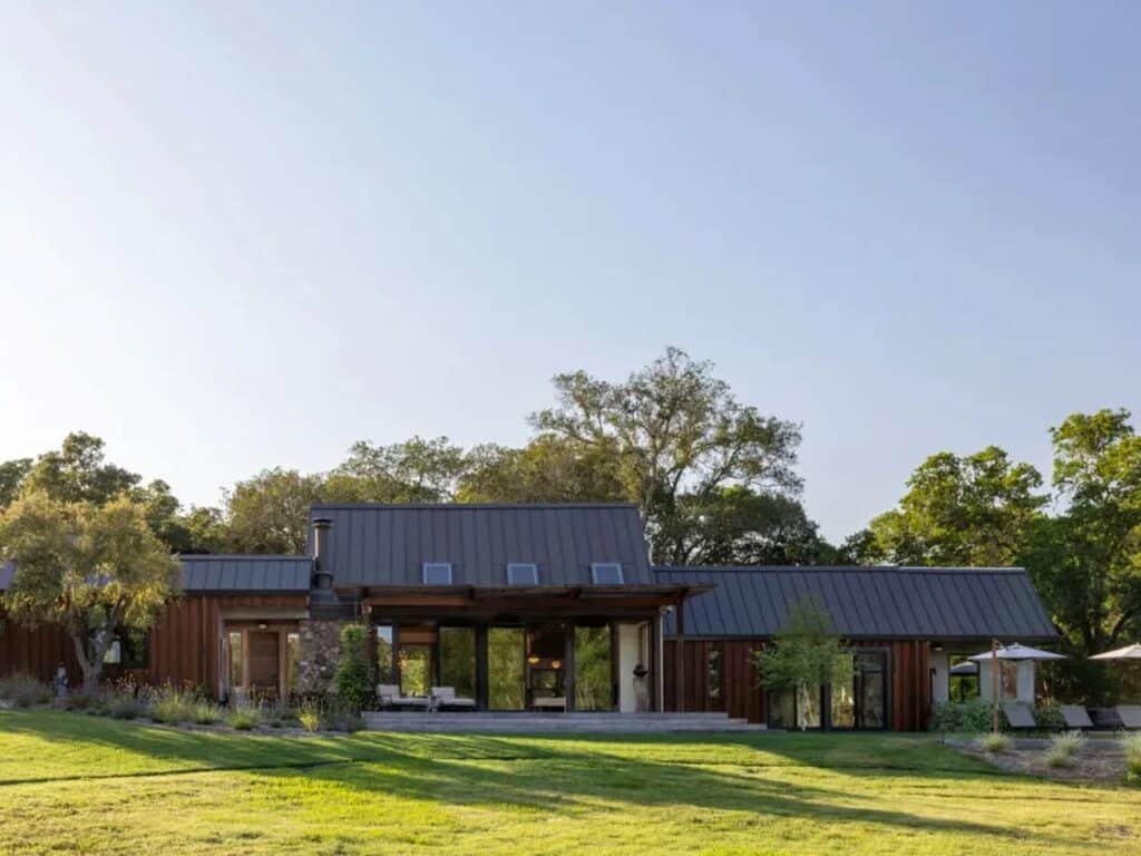Exterior view of the Glen Ellen house showing the original metal roof and integration with the Sonoma landscape.