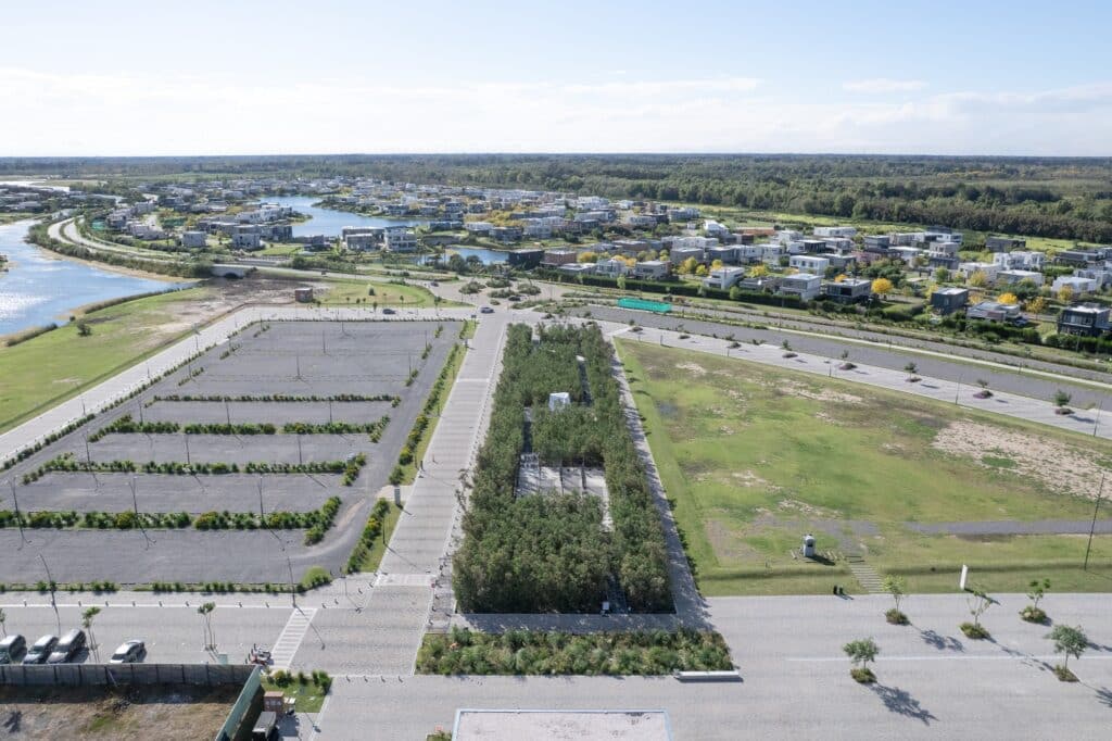 Aerial perspective of Malba Puertos project showing the rectangular forest strip integrated into the urban fabric and parking areas.