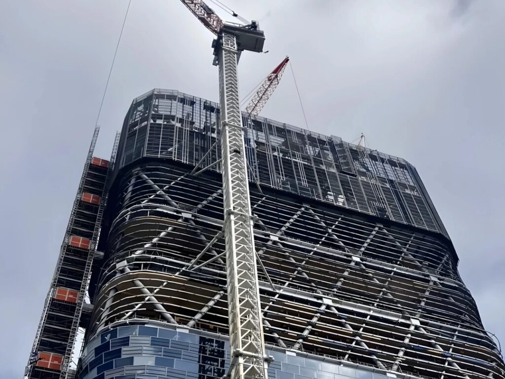 Low-angle shot of Atlassian Central Sydney under construction showing the hybrid steel and mass timber exoskeleton.